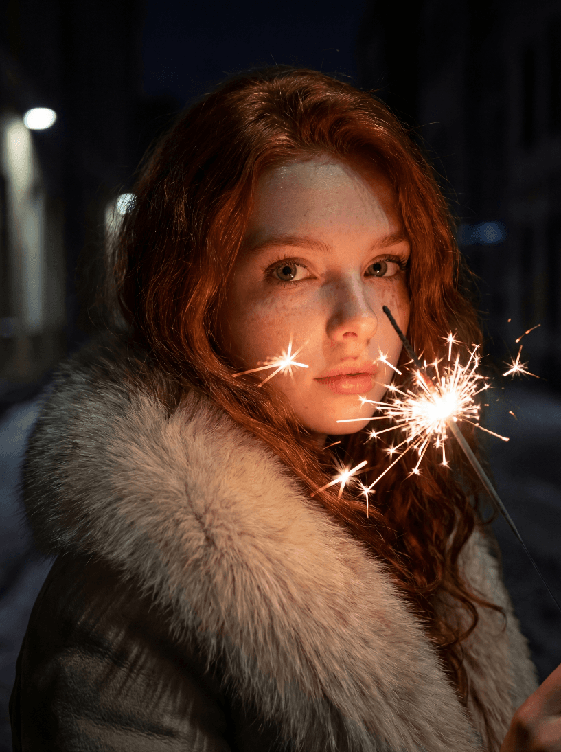 Портрет рыжеволосой женщины с бенгальским огнем ночью